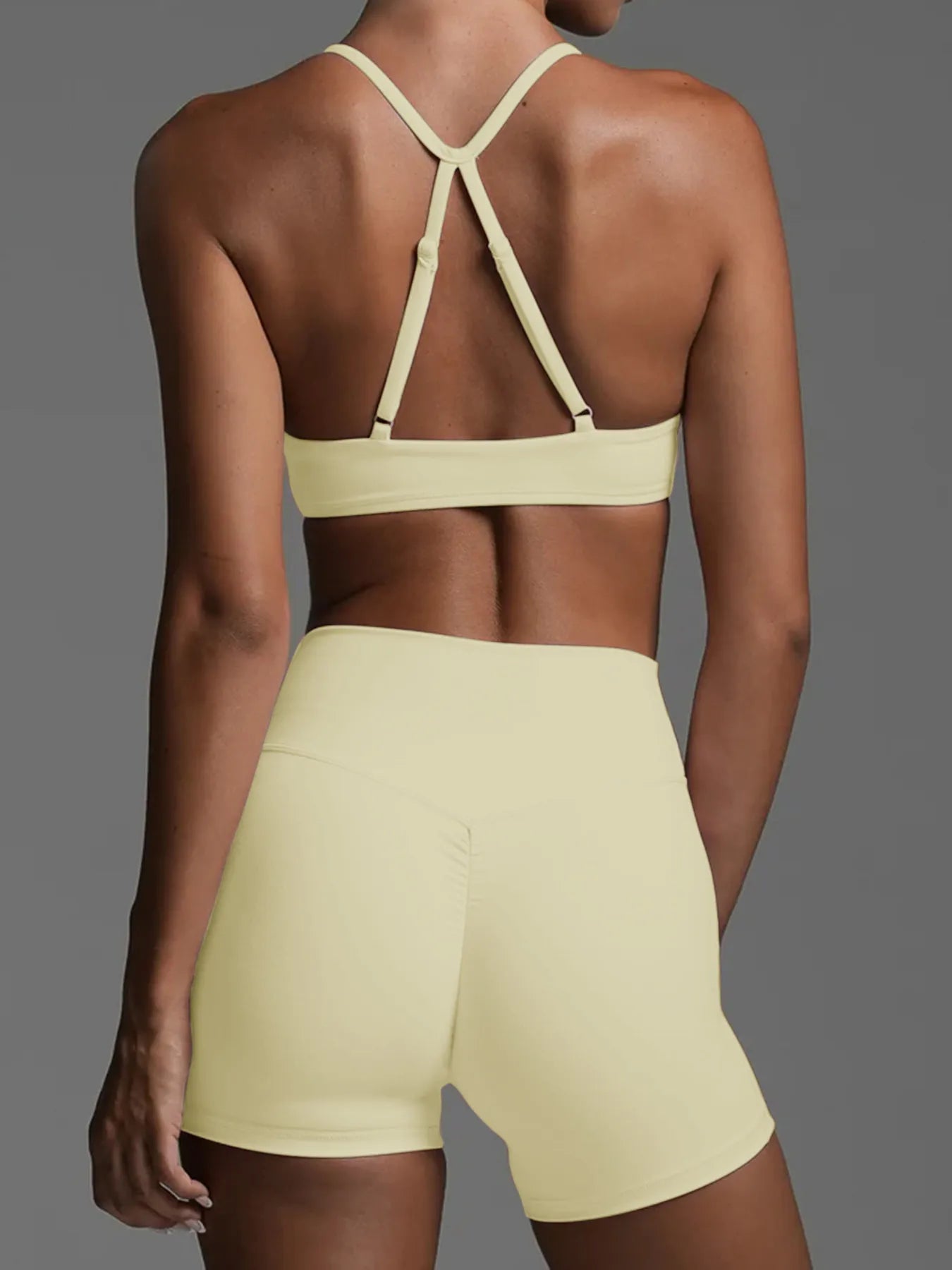 Back view of women's yellow activewear featuring a sports bra and matching Shorts Active Set