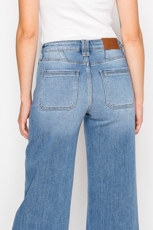 Artemis Vintage back view of women's eco-friendly palazzo jeans light wash high waist wide leg with patch pockets