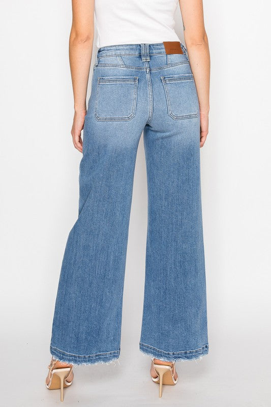 Artemis Vintage model wearing women's eco-friendly palazzo jeans back view high waist light wash frayed hem
