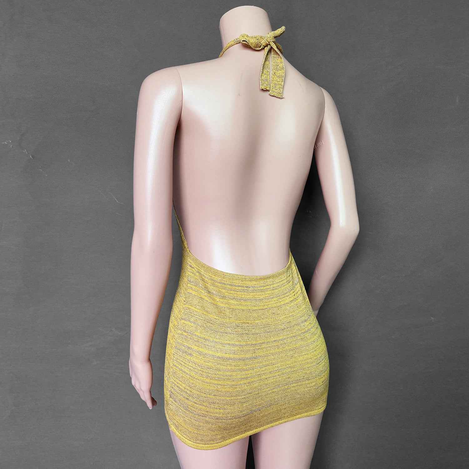 Stylish backless mini dress in yellow with a halter neck design for a chic summer look