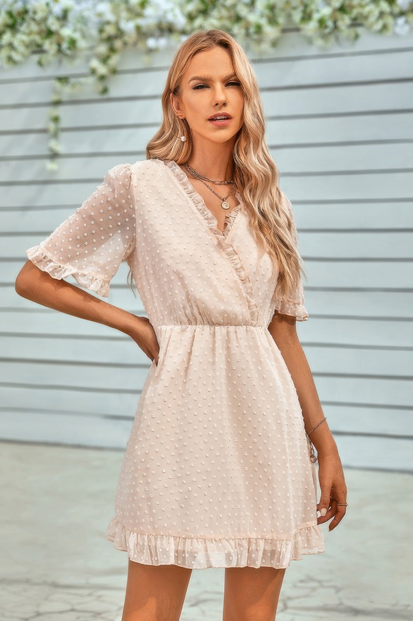 CCWHOLESALECLOTHING model wearing a cream swiss dot ruffle midi dress with V neck elastic waist and ruffled hem