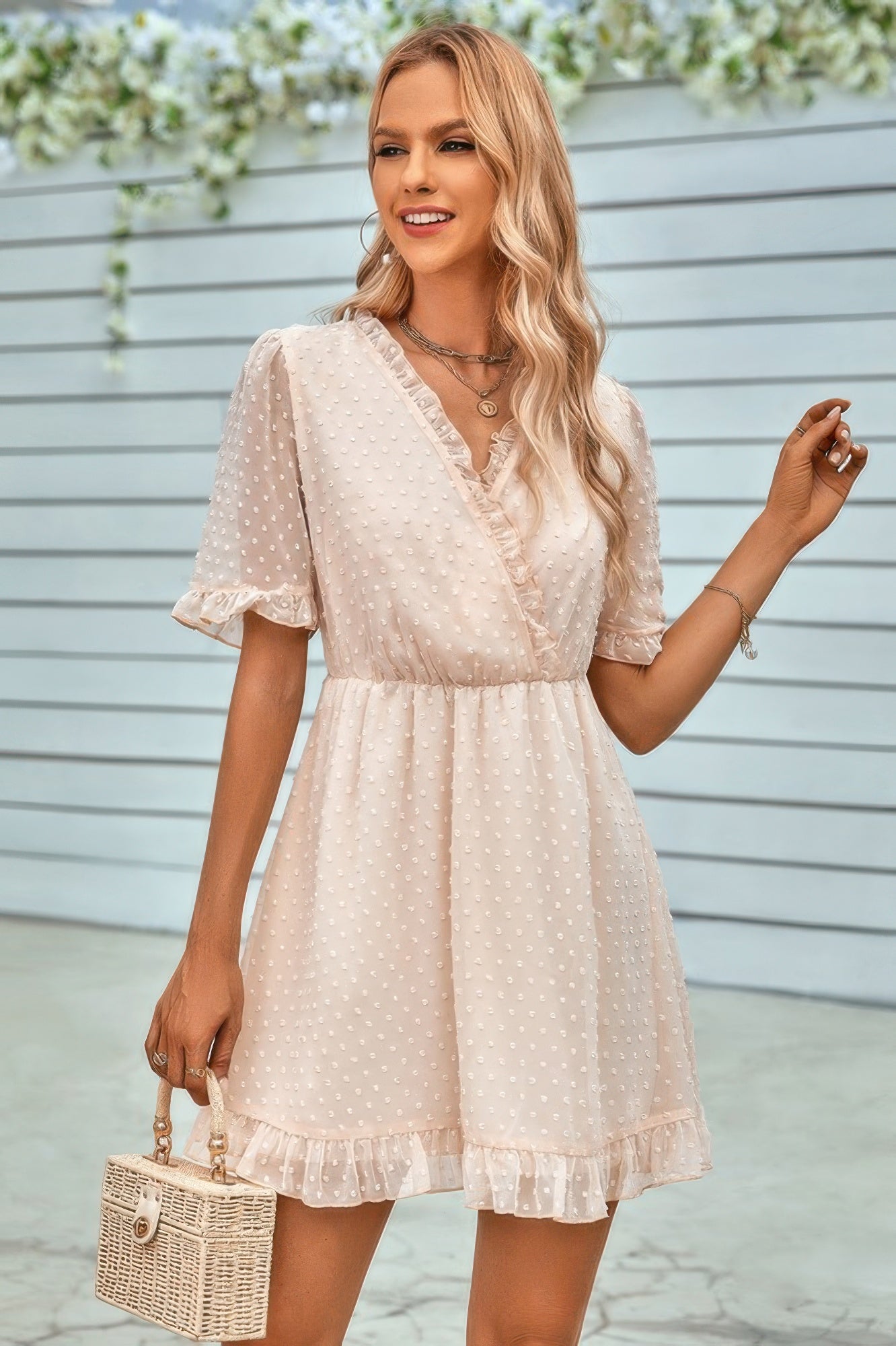 CCWHOLESALECLOTHING model wearing a cream swiss dot ruffle midi dress with V neck short puff sleeves and ruffle hem