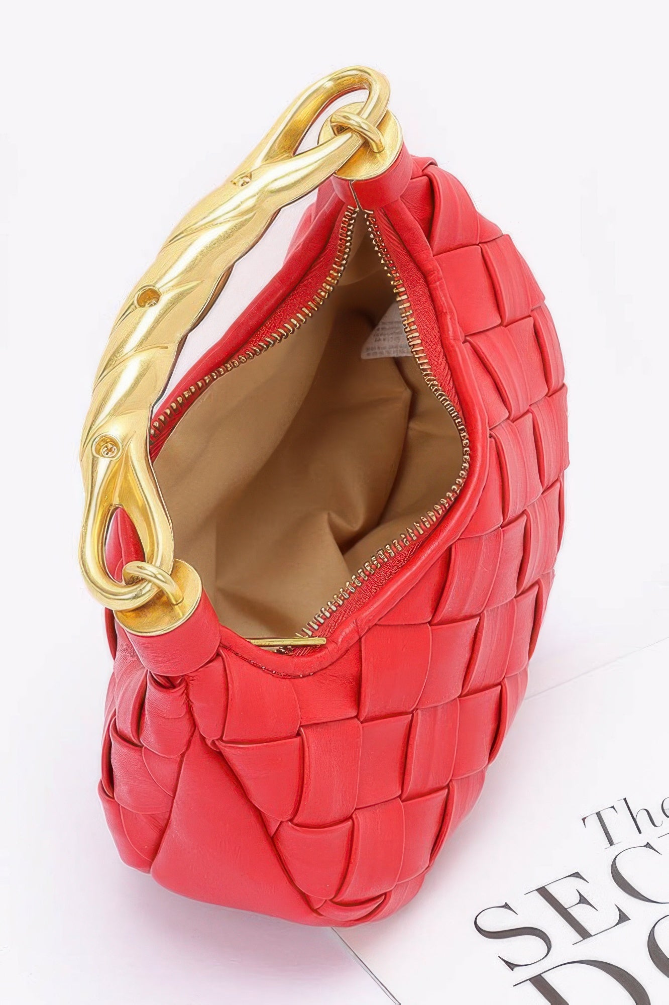 red woven hobo purse with gold twisted handle and zipper showing beige interior faux leather braided handle bag