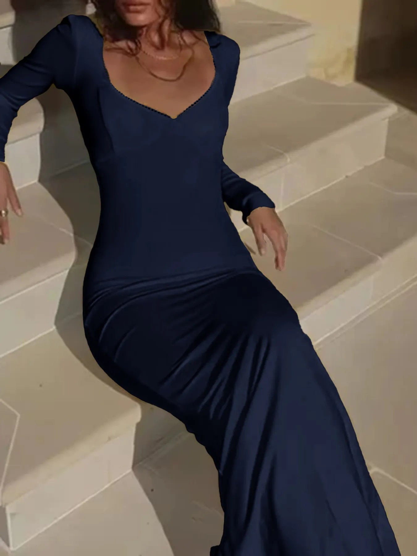 Trendsi navy long sleeve Figure-Hugging Evening Dress with sweetheart neckline worn by seated model on steps