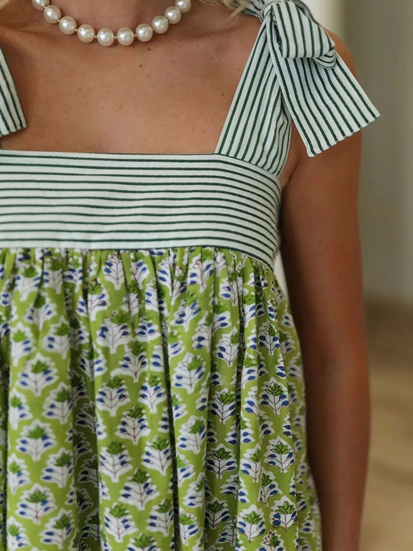 Trendsi Tie Shoulder Summer Dress close up of green floral skirt with striped square bodice and bow straps