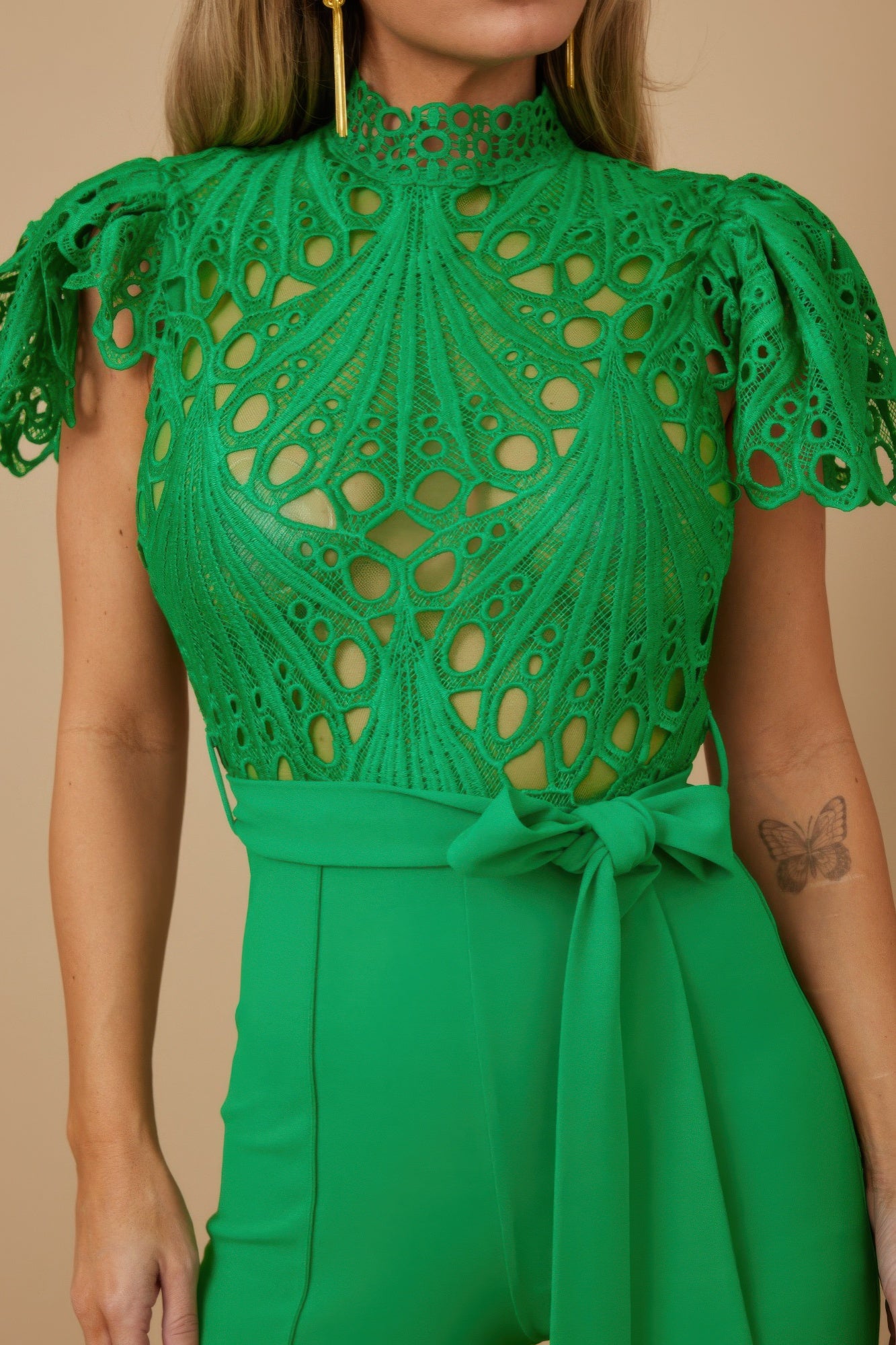 Green crochet jumpsuit for women with high neck lace bodice puff sleeves and tied waist trousers