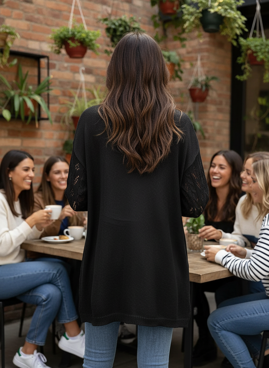 Black openwork cardigan - brunette rear view at cafe