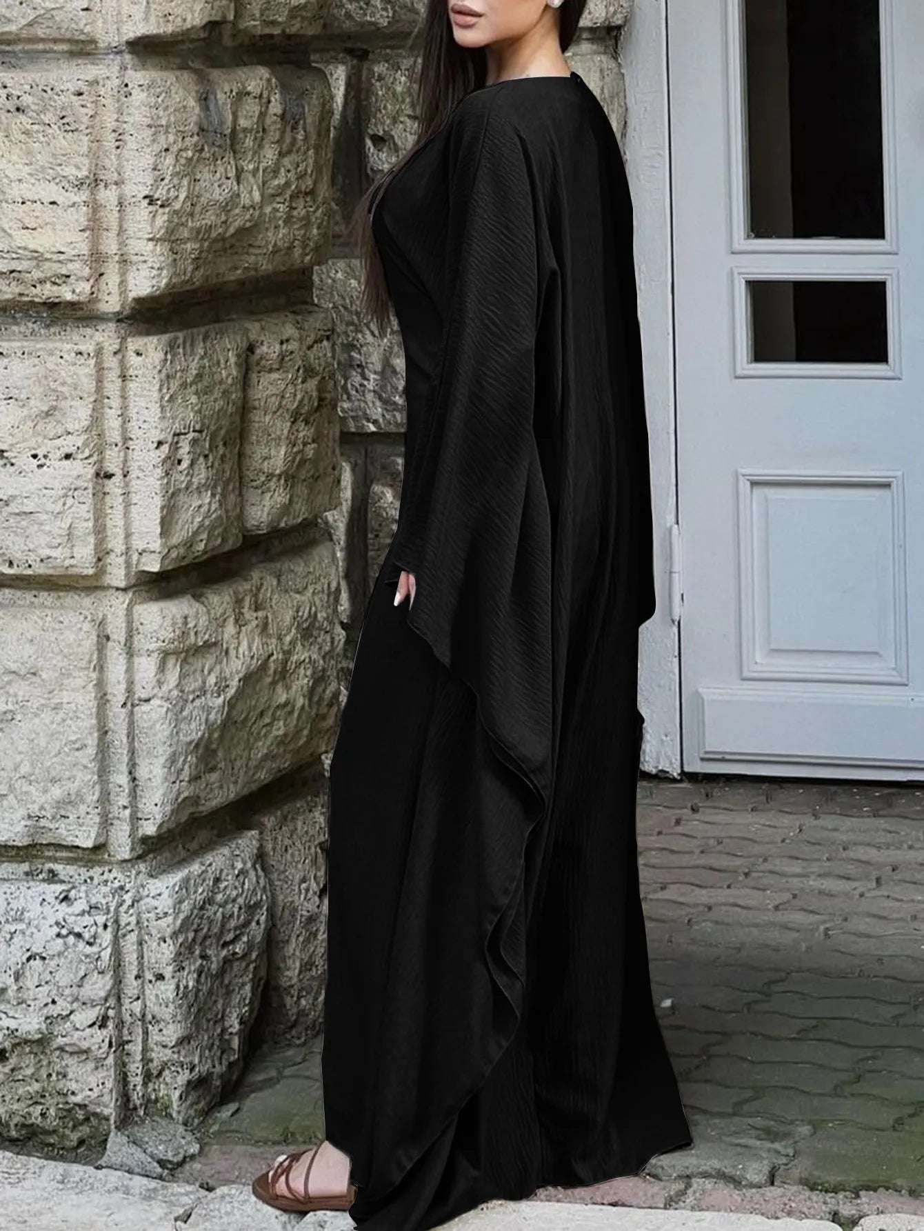 Trendsi black bohemian maxi dress with cape sleeves flowing side view on model for elegant casual or evening wear