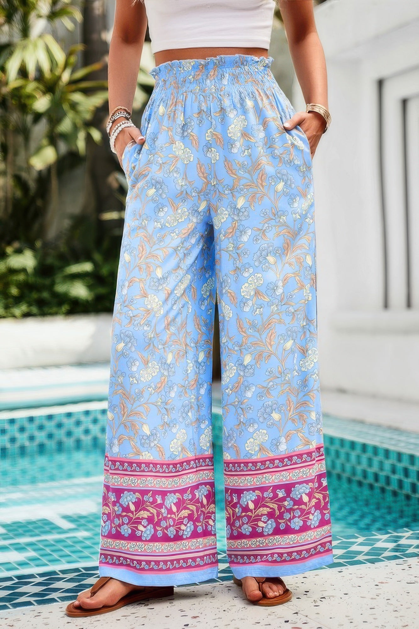 Blue boho floral wide leg pants for women with smocked high waist and pink border hem by CCWHOLESALECLOTHING
