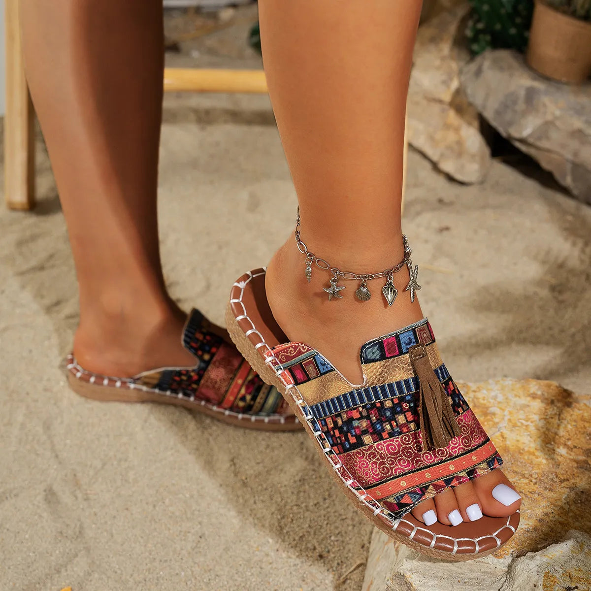 Trendsi Boho Tassel Slide Sandals with colorful patterns and decorative tassels on sandy beach