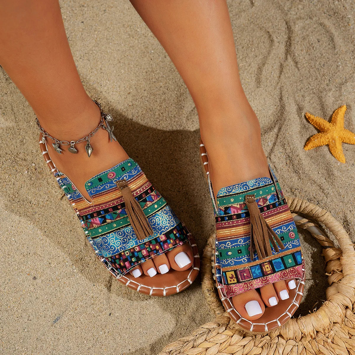 Trendsi Boho Tassel Slide Sandals with colorful patterned straps and brown tassels on sandy beach