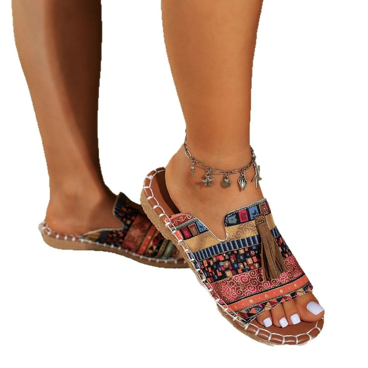 Trendsi Boho Tassel Slide Sandals with multicolor patterned fabric and brown tassel detail on foot