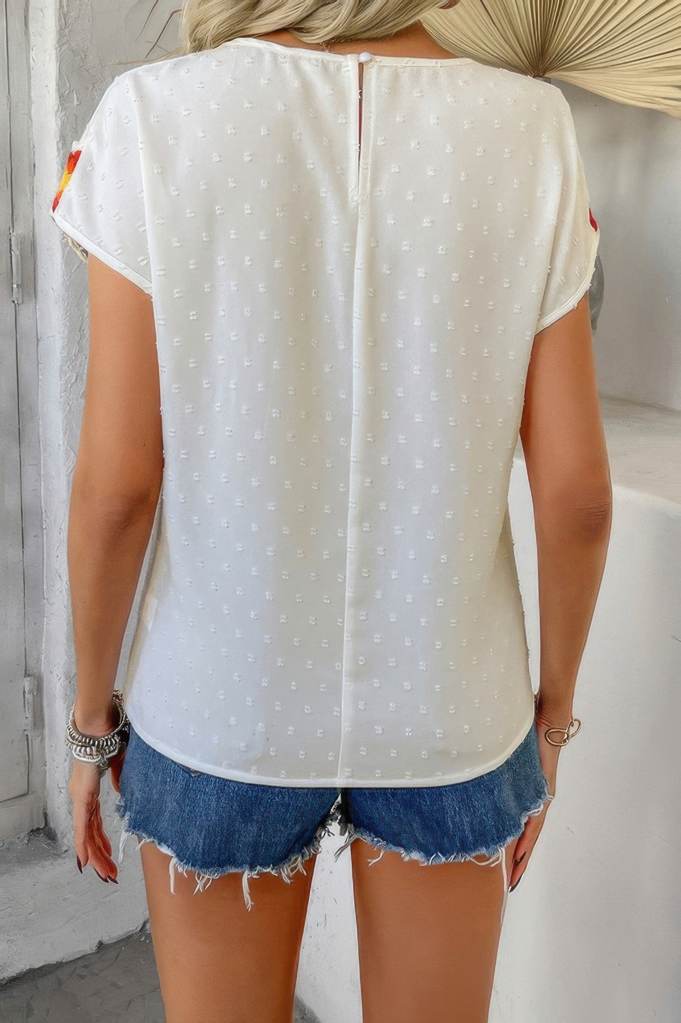 CCWHOLESALECLOTHING white Swiss dot crochet patchwork shirt back view with center seam zipper and denim cutoff shorts