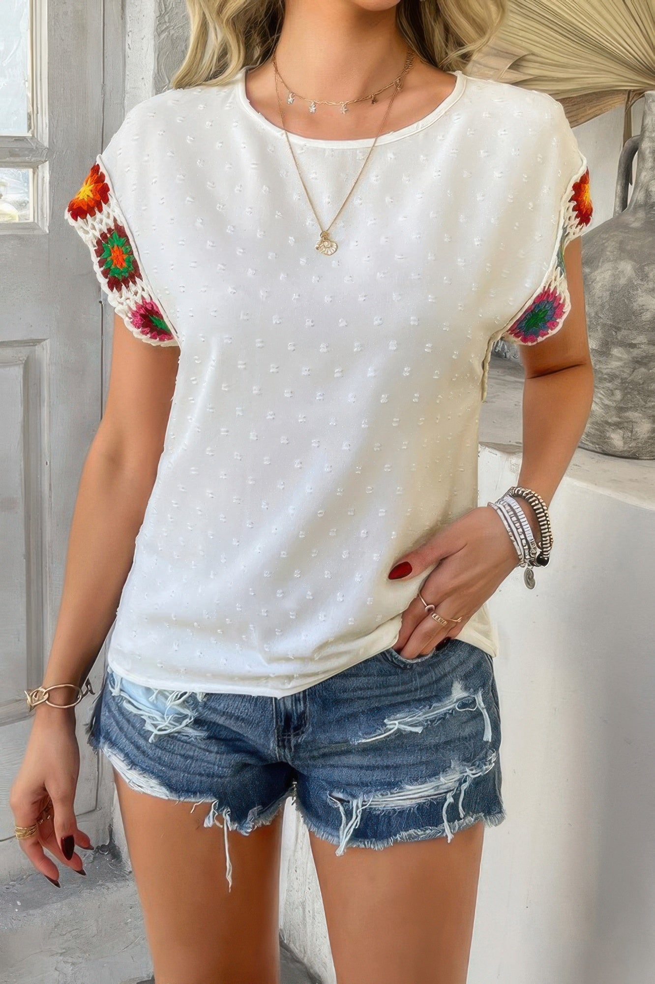 Swiss dot crochet patchwork shirt white textured top with colorful crochet sleeve patches styled with denim shorts