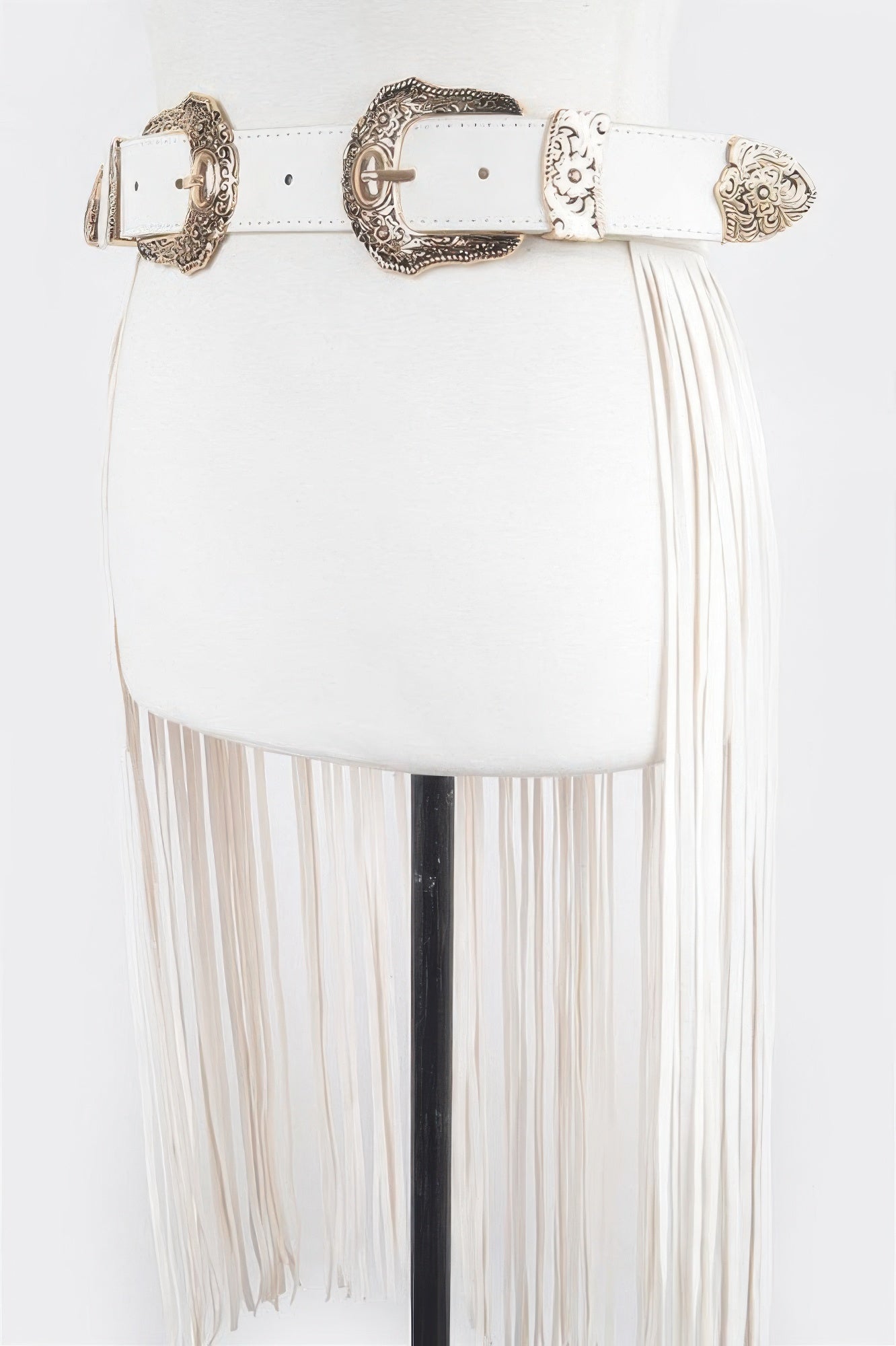 White leather double buckle fringe belt with ornate bronze buckles and long side fringe on mannequin