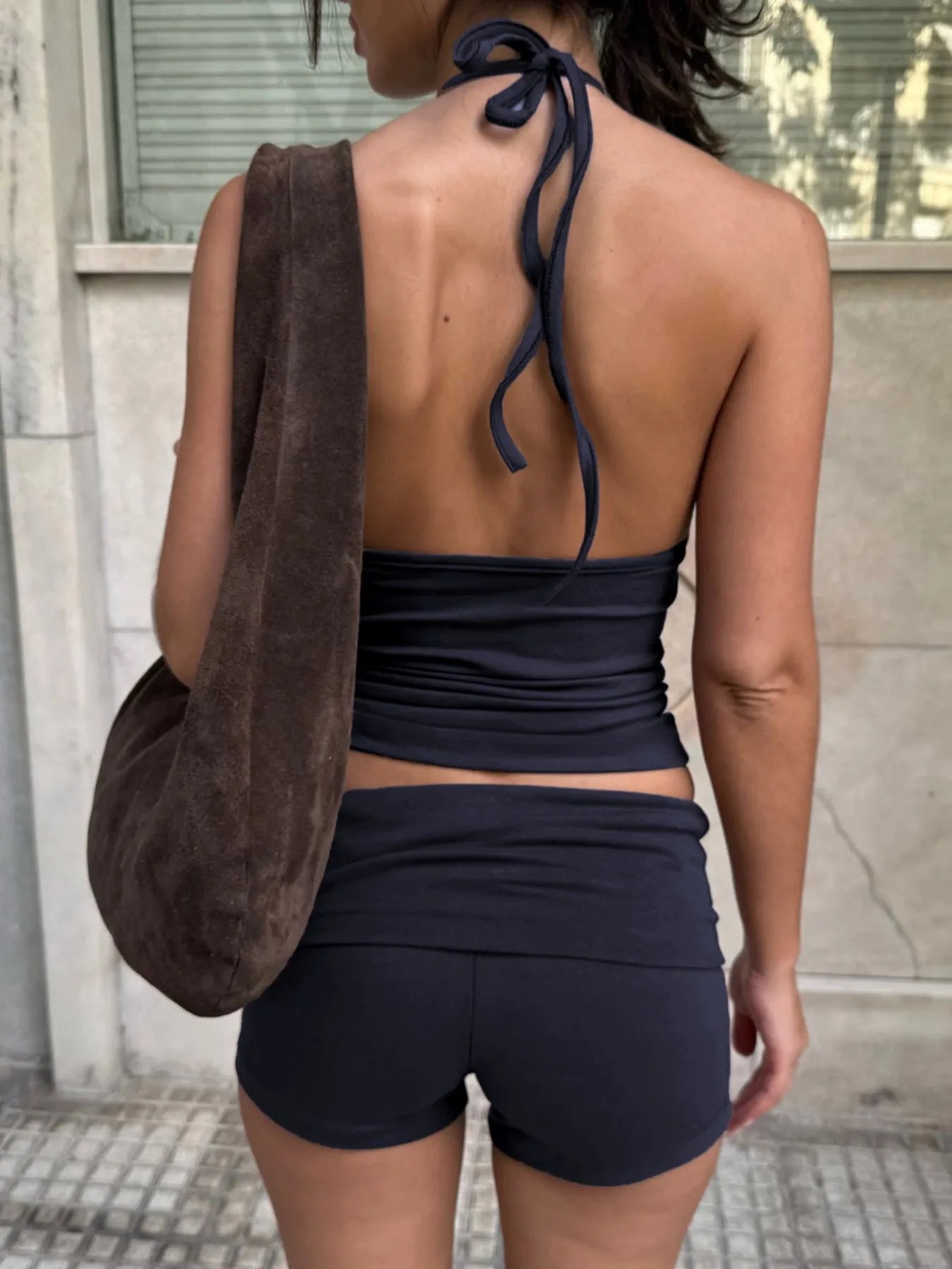Trendsi Cami and Shorts Set in black, featuring a halter neck design and fitted shorts
