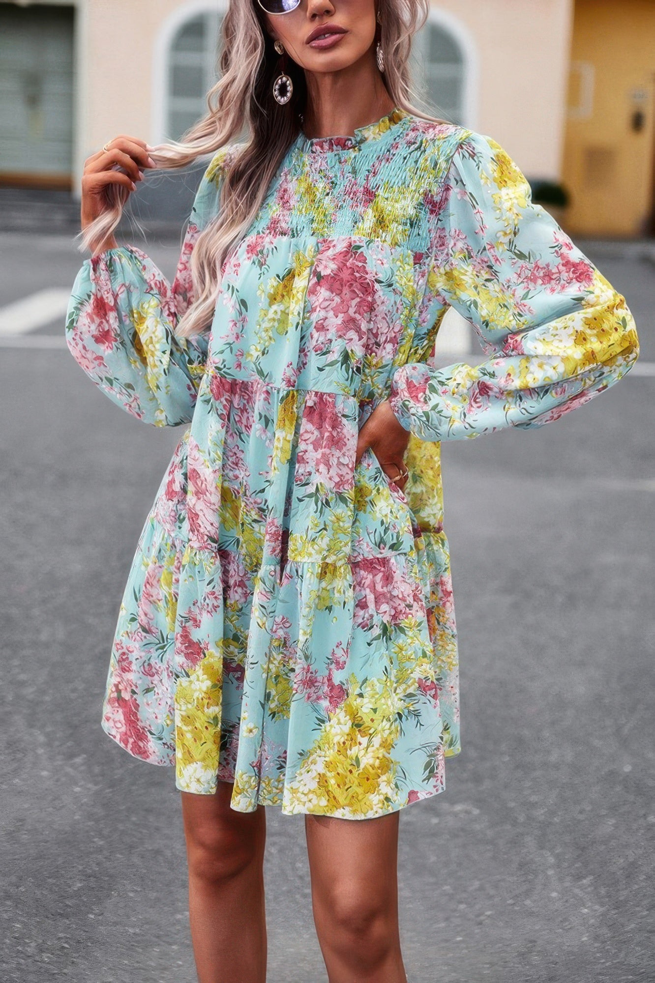 Light blue floral print smock dress with smocked yoke long puff sleeves and tiered above knee skirt