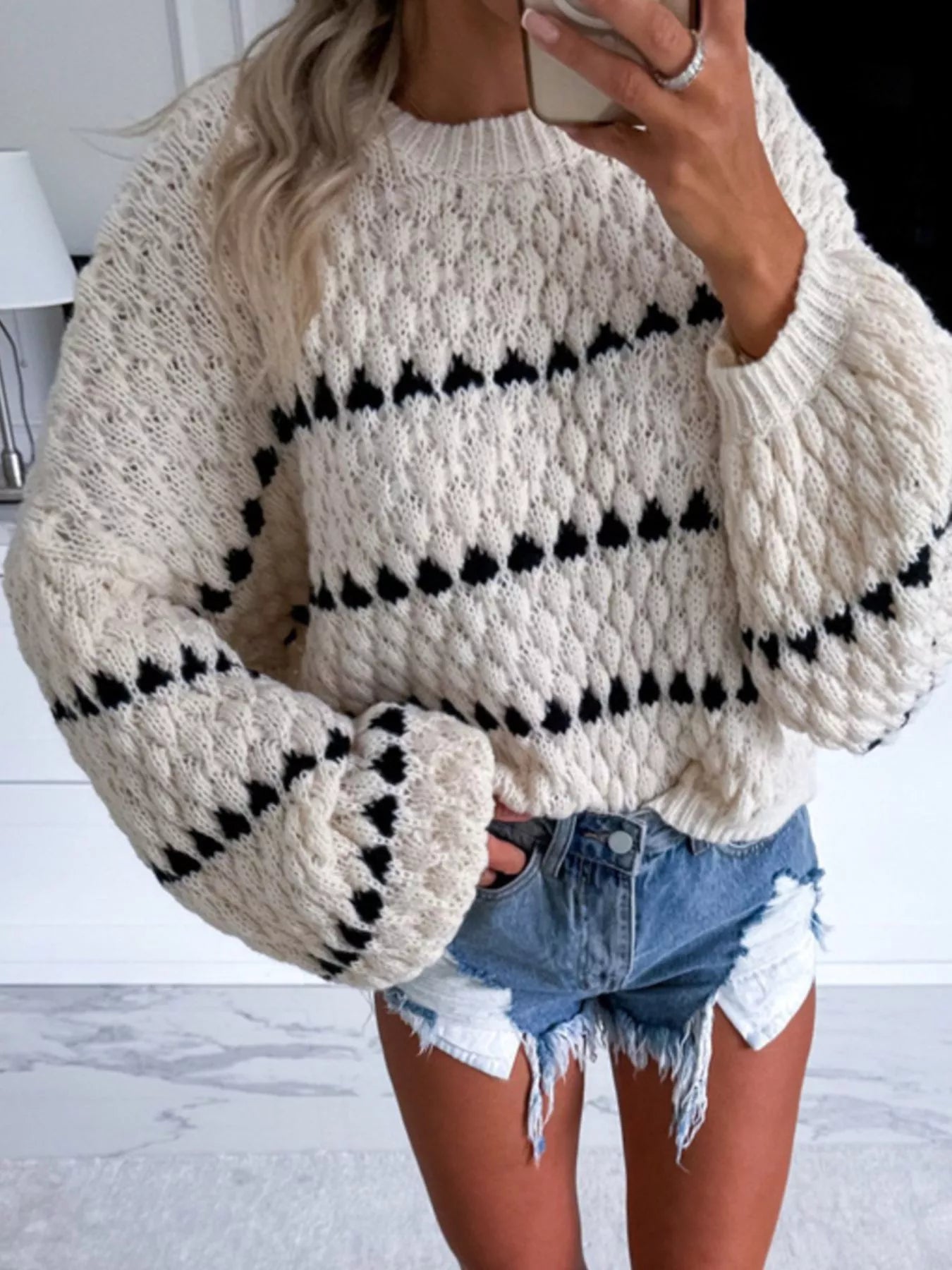 Chunky Knit Striped Sweater in cream and black paired with denim shorts on a model