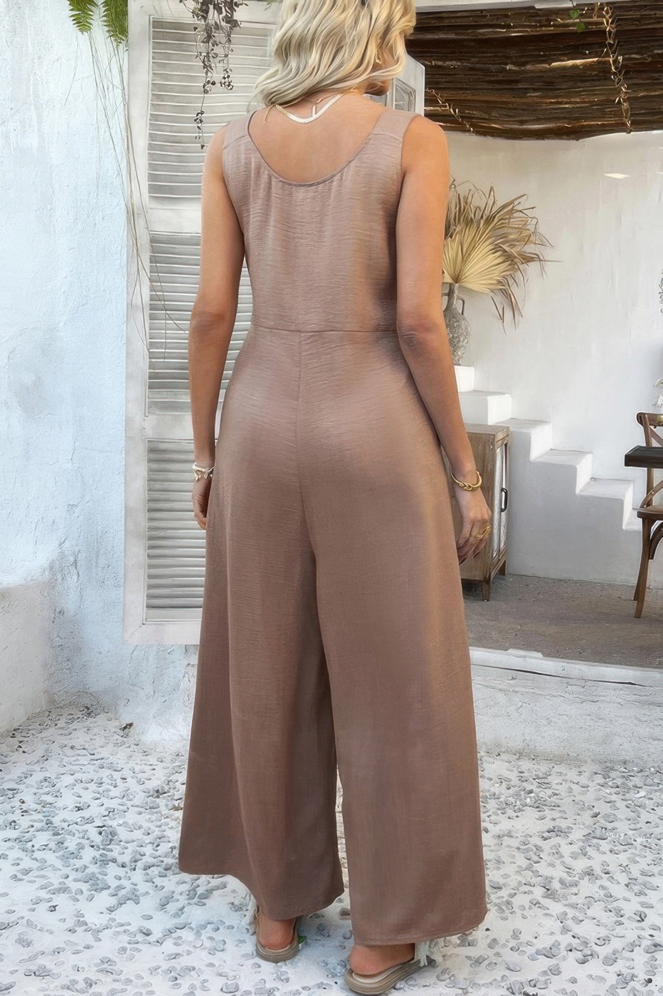Wide Leg Jumpsuit taupe sleeveless scoop back relaxed fit on model with sandals boho outdoor setting