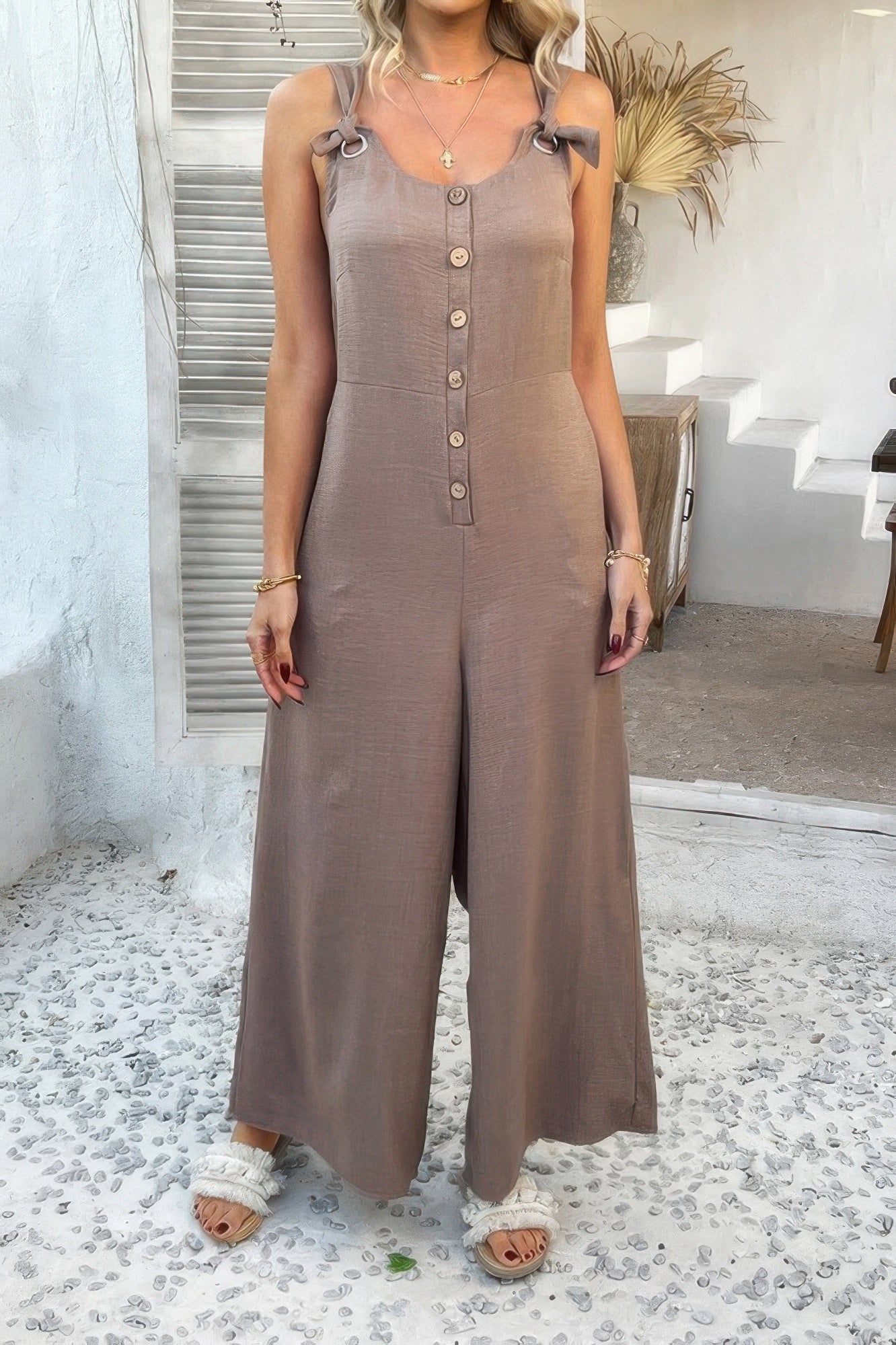 Wide Leg Jumpsuit in taupe with button front and tie shoulder straps on model for casual wear