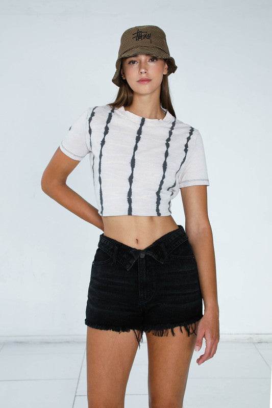 Model wearing Insane Gene Dark Wash Denim Shorts paired with a stylish bucket hat
