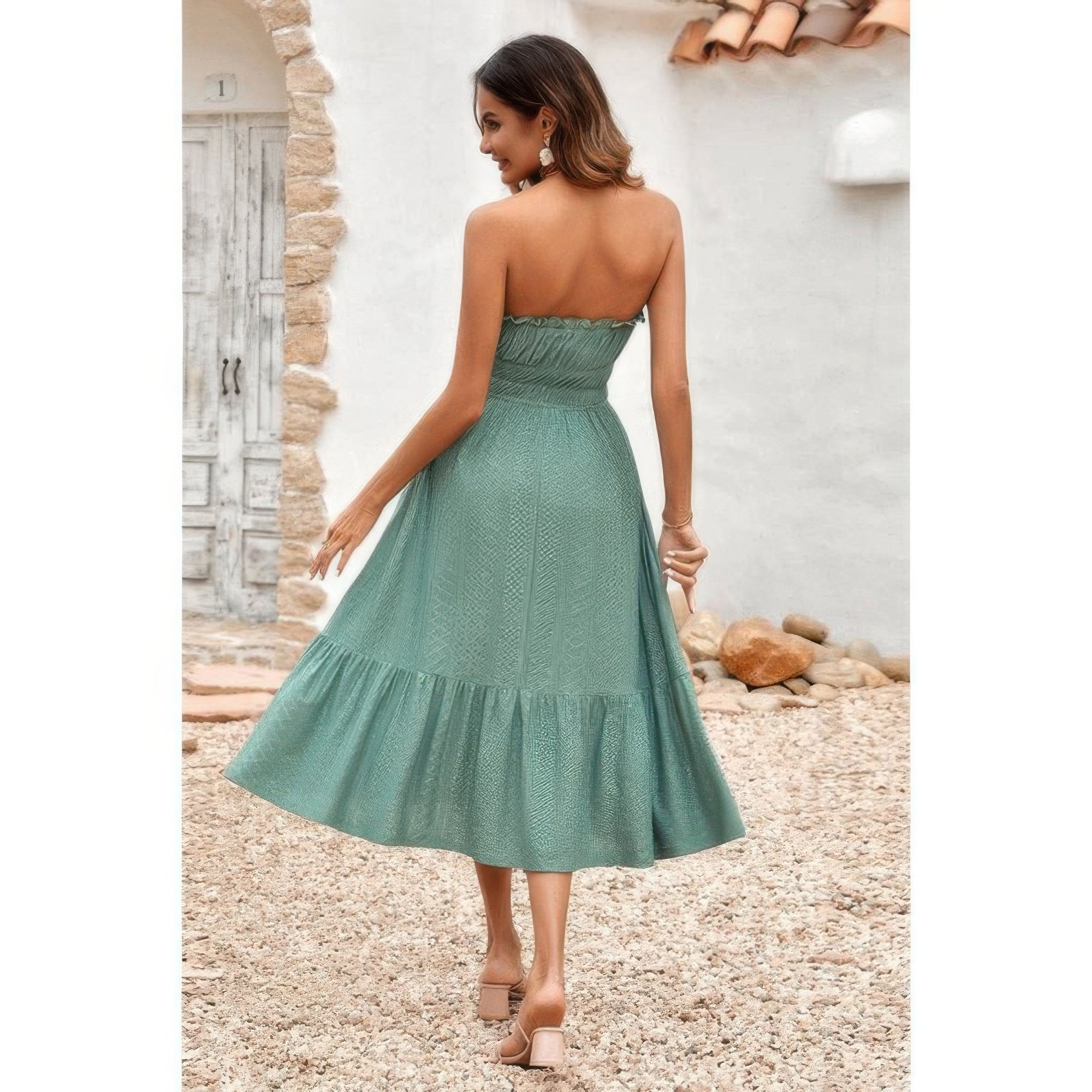 Woman wearing green strapless Elasit Waist Ruffle Dress with smocked elastic waist and ruffle hem outdoors