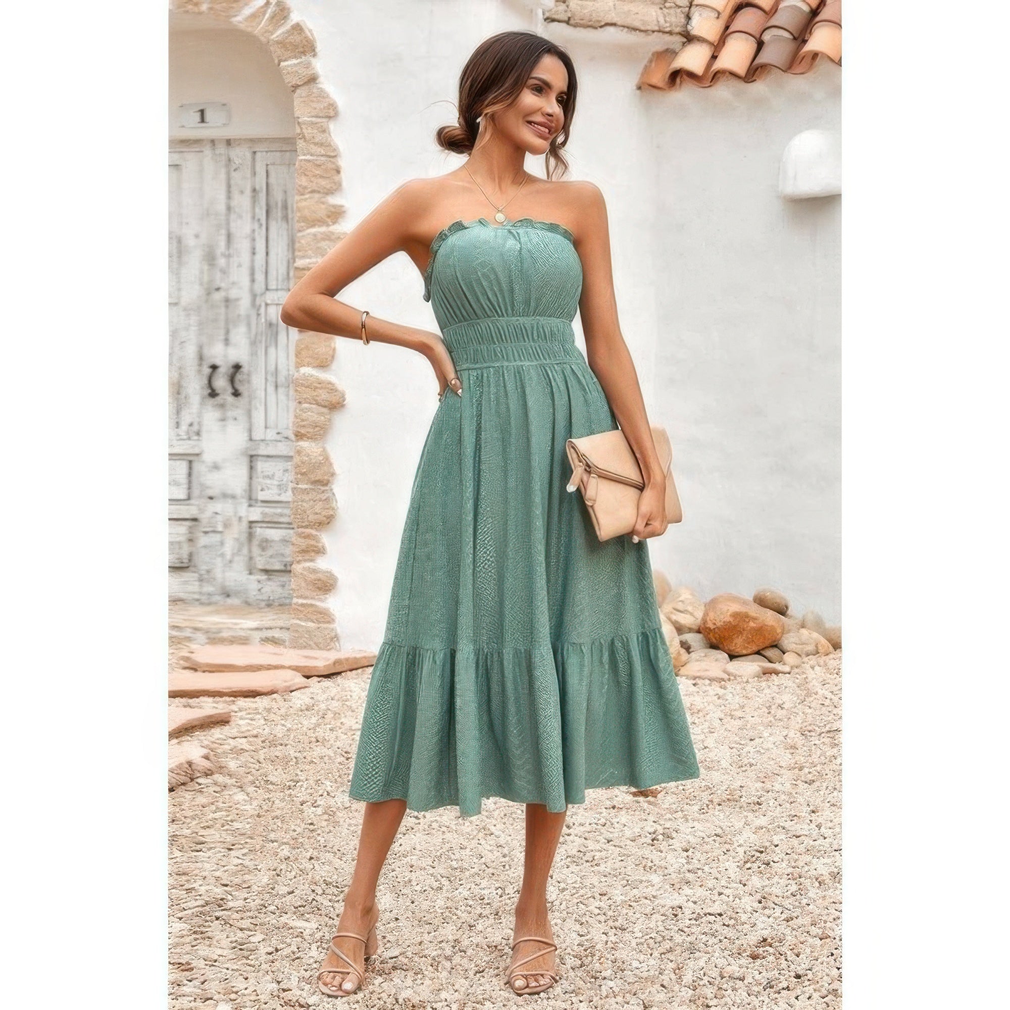 Elasit Waist Ruffle Dress green strapless midi dress with smocked elastic waist ruffle hem model holding clutch