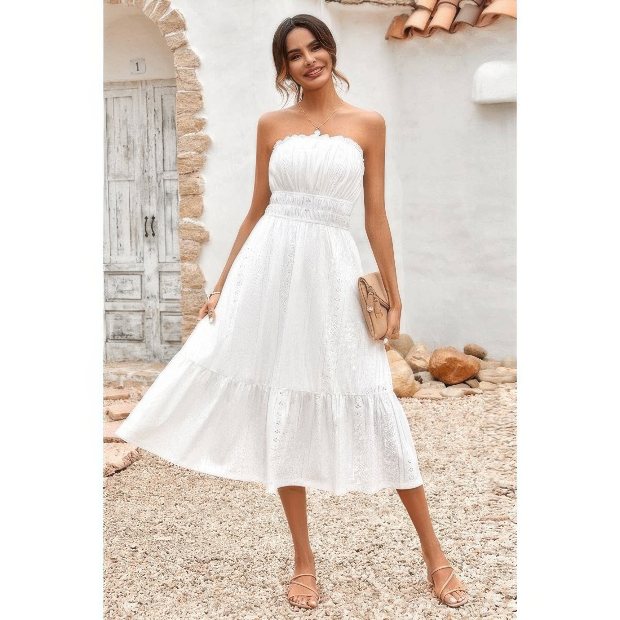 Model wearing Elasit Waist Ruffle Dress white strapless midi with smocked bodice tiered skirt and clutch