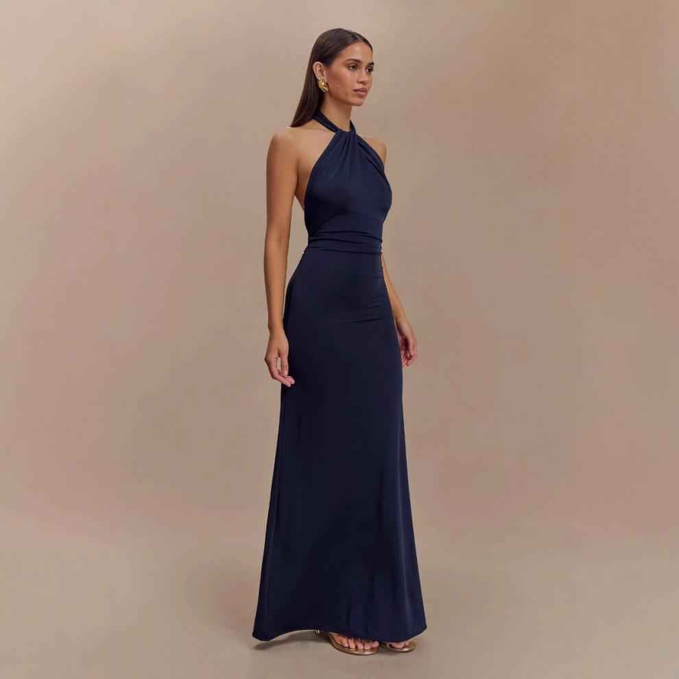 Chic model wearing an Elegant Formal Gown in navy blue with a halter neckline and fitted silhouette