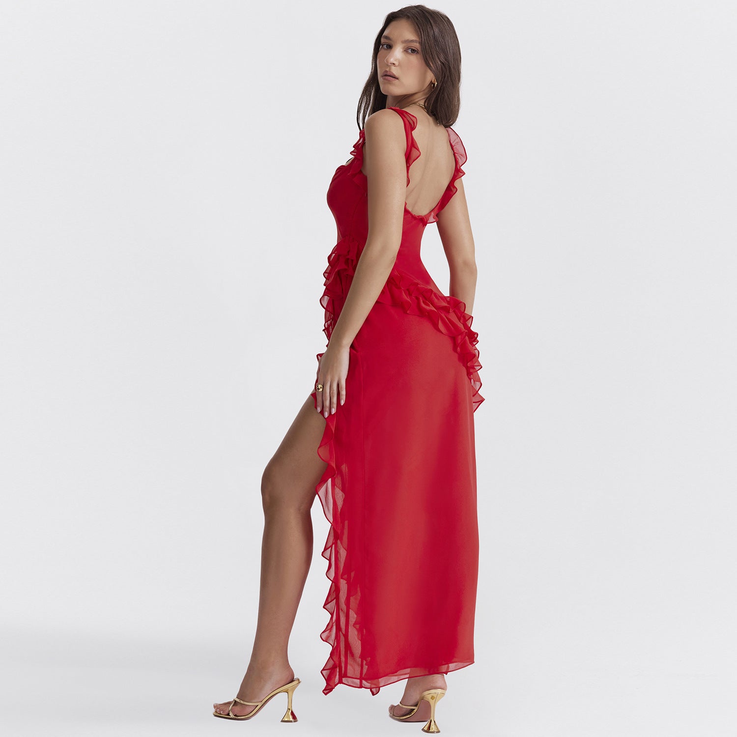 Elegant Ruffled Evening Maxi Dress in red with open back and high slit worn by woman