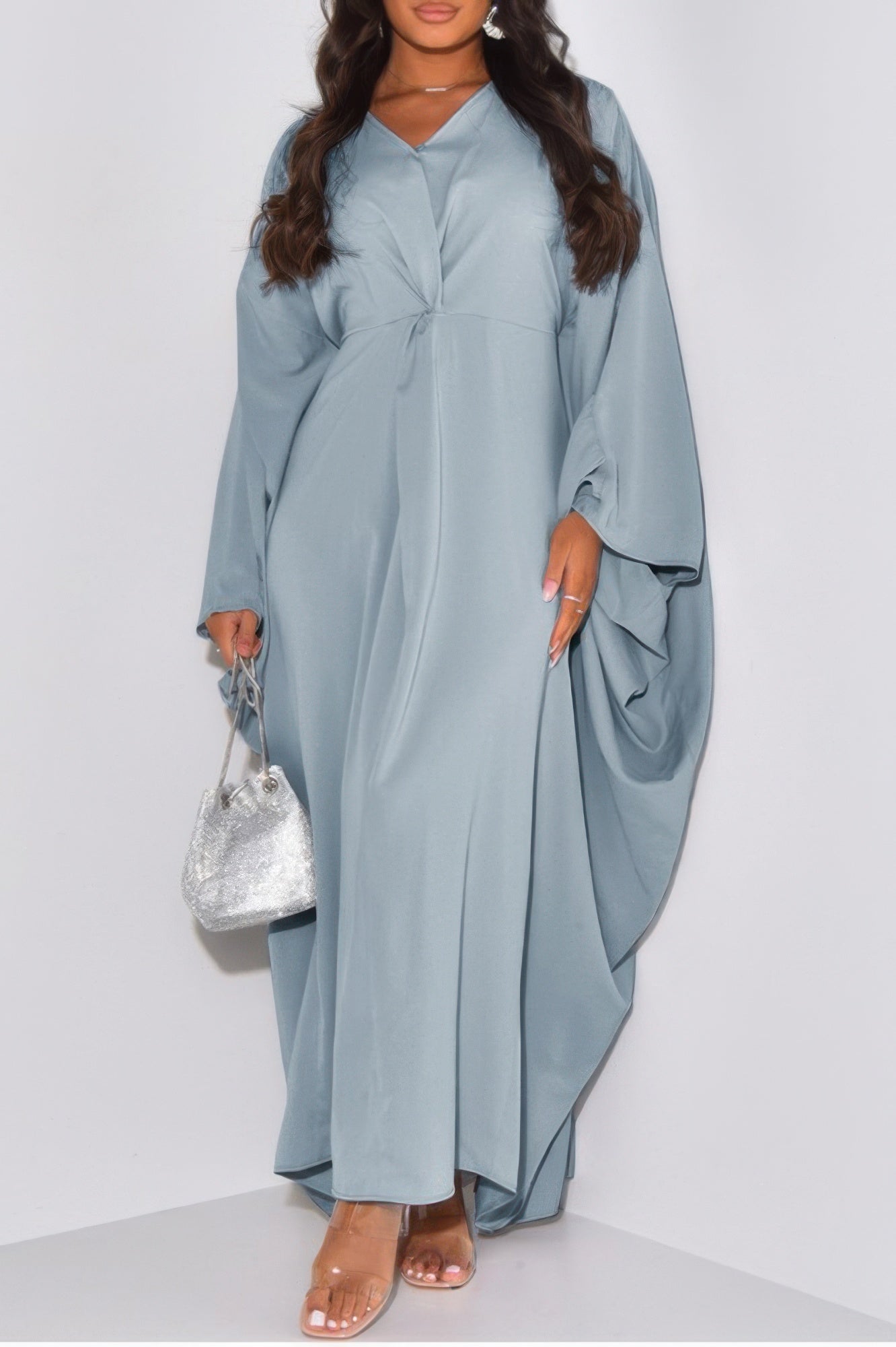 CCWHOLESALECLOTHING loose fit v neck maxi dress in light blue with draped batwing sleeves front twist model with silver bag