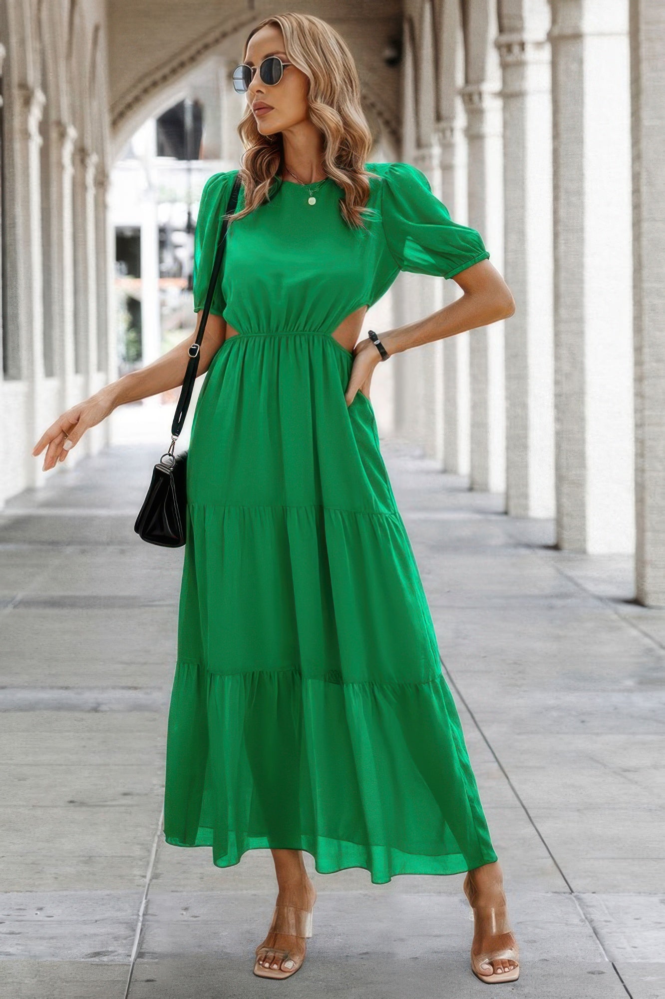 Green maxi Puff Sleeves Fit Dress with cutout waist and tiered skirt worn with sunglasses and black shoulder bag