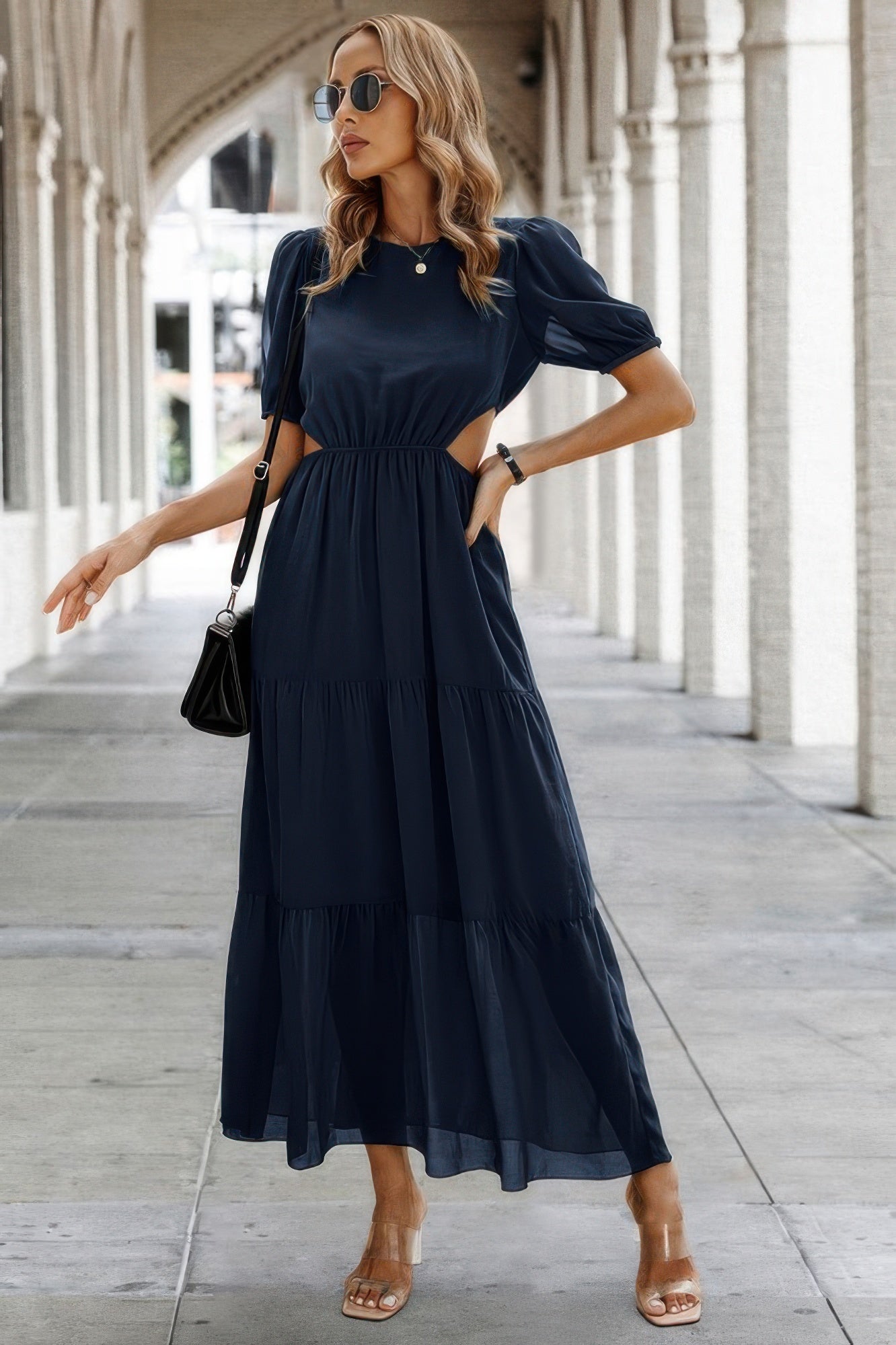 Woman wearing navy Puff Sleeves Fit Dress maxi with waist cutouts tiered skirt sunglasses black bag sandals