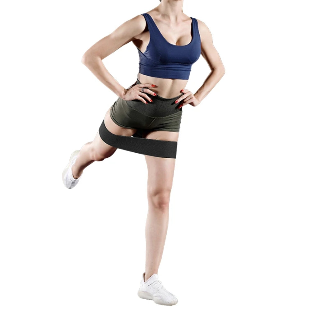 Fashions Envy Hip Booty Bands woman in blue sports bra and green shorts using black band for glute workout
