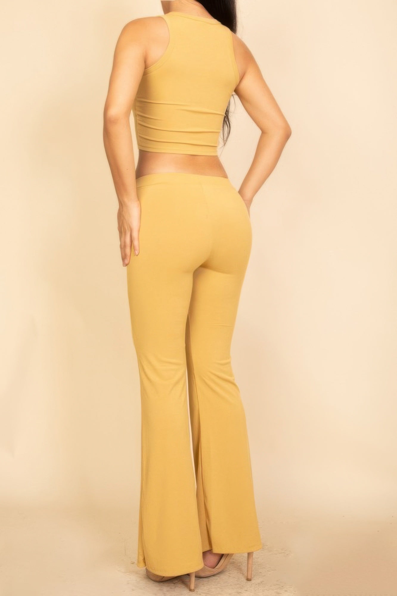 Yellow Flared Pants Set featuring a sleeveless crop top and flared trousers for a stylish look