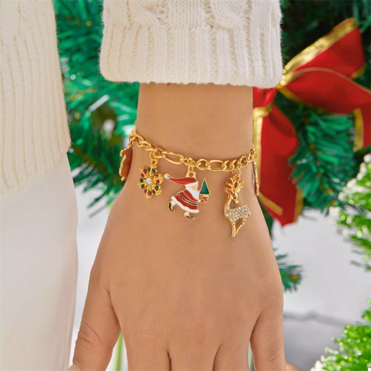 Stylish gold-plated charm bracelet with festive charms, perfect for holiday celebrations