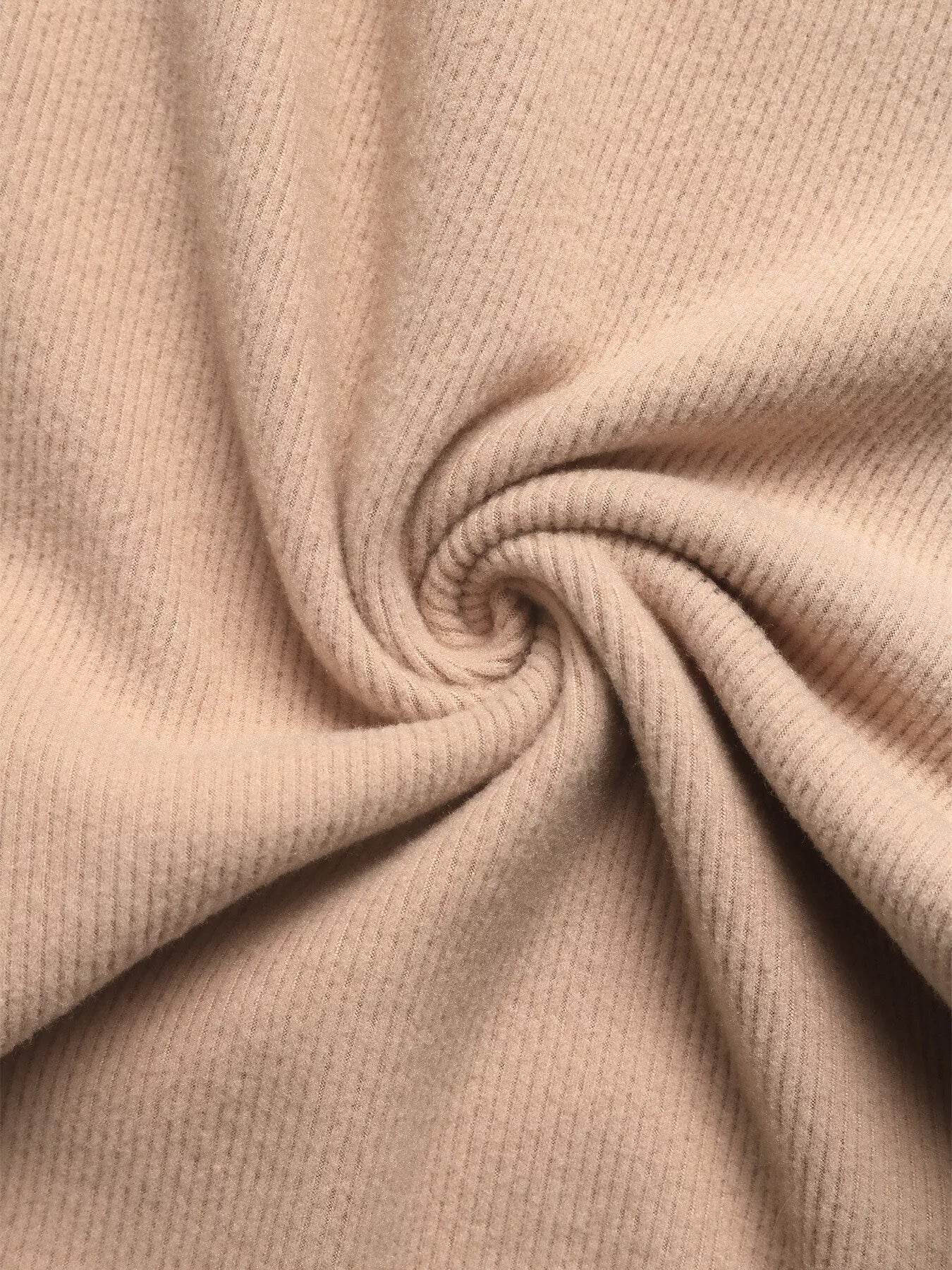Soft and comfortable fabric close-up of a hoodie and pants set in a neutral beige color