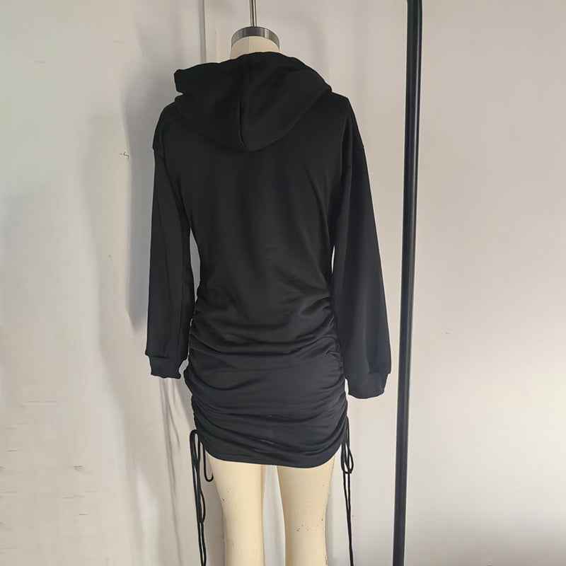 Back view of a black Hoodie Mini Dress with adjustable ruching and a relaxed fit