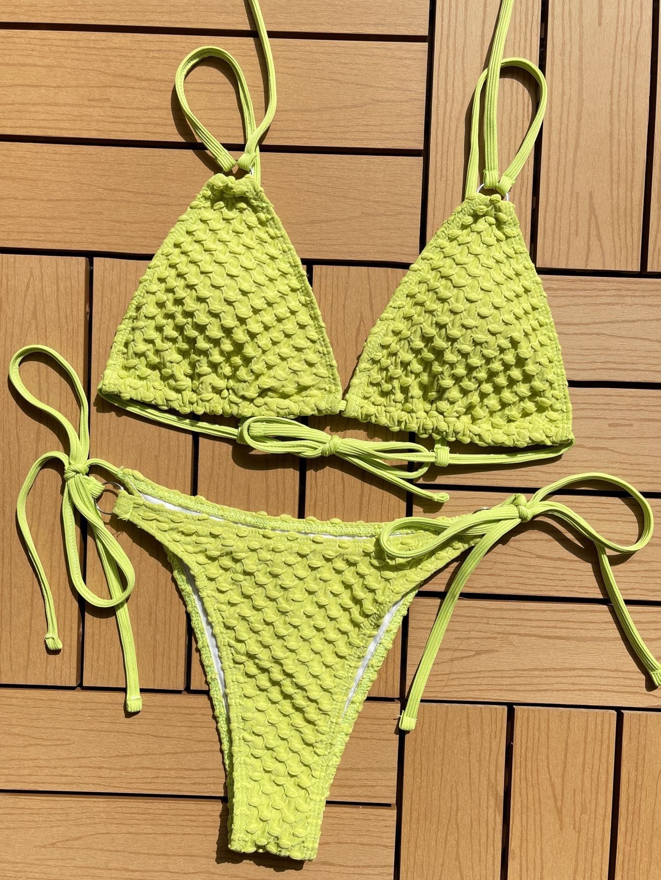 Trendsi knit textured bikini summer swimwear in bright yellow with adjustable ties on wood background
