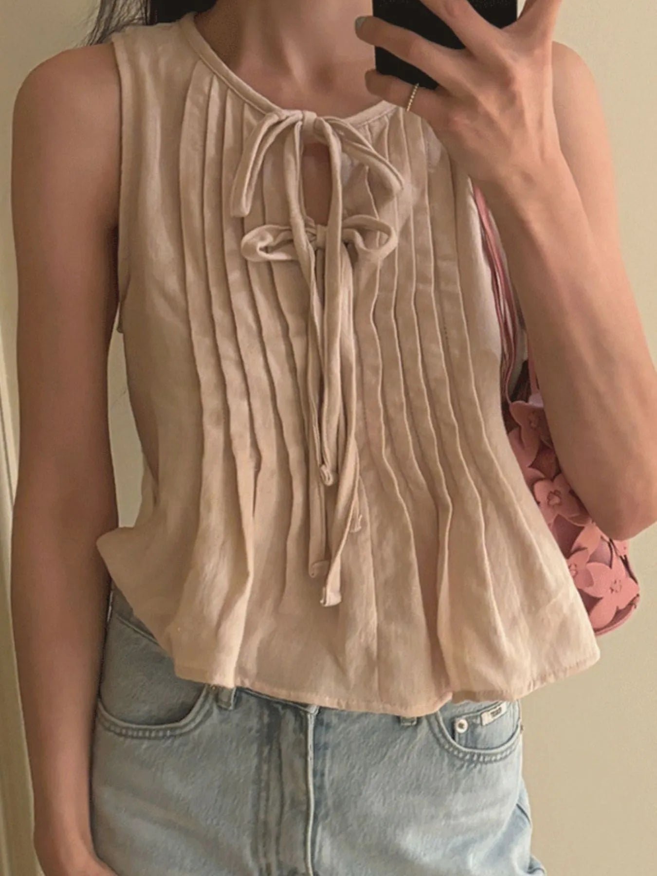 Trendsi beige pleated Sleeveless Summer Blouse with front tie detail worn by model with denim jeans