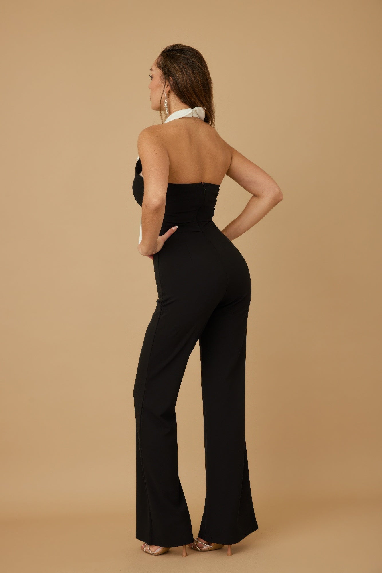 CCWHOLESALECLOTHING back view black halter fashion jumpsuit with bow tied at neck fitted waist wide leg pants