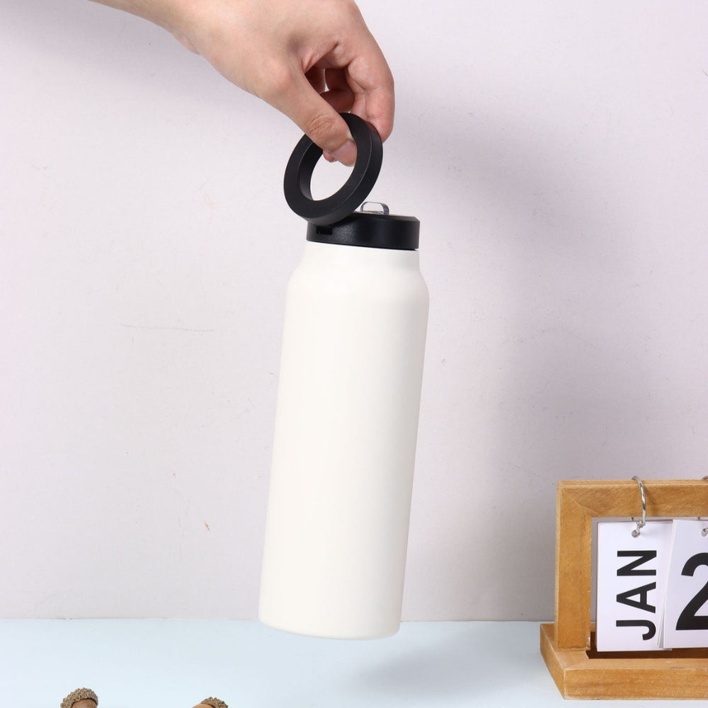 Fashions Envy white stainless water bottle with black lid held by hand and Magnetic Phone Holder ring