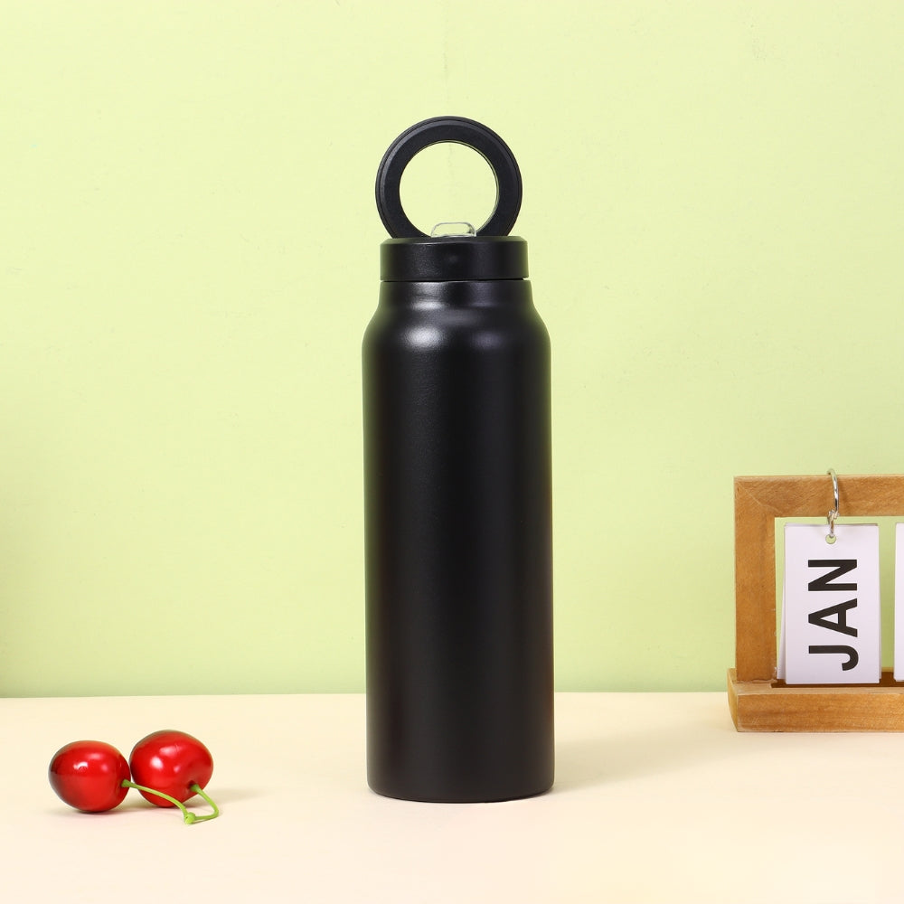 Fashions Envy black stainless water bottle with loop cap on table with cherries and JAN block Magnetic Phone Holder