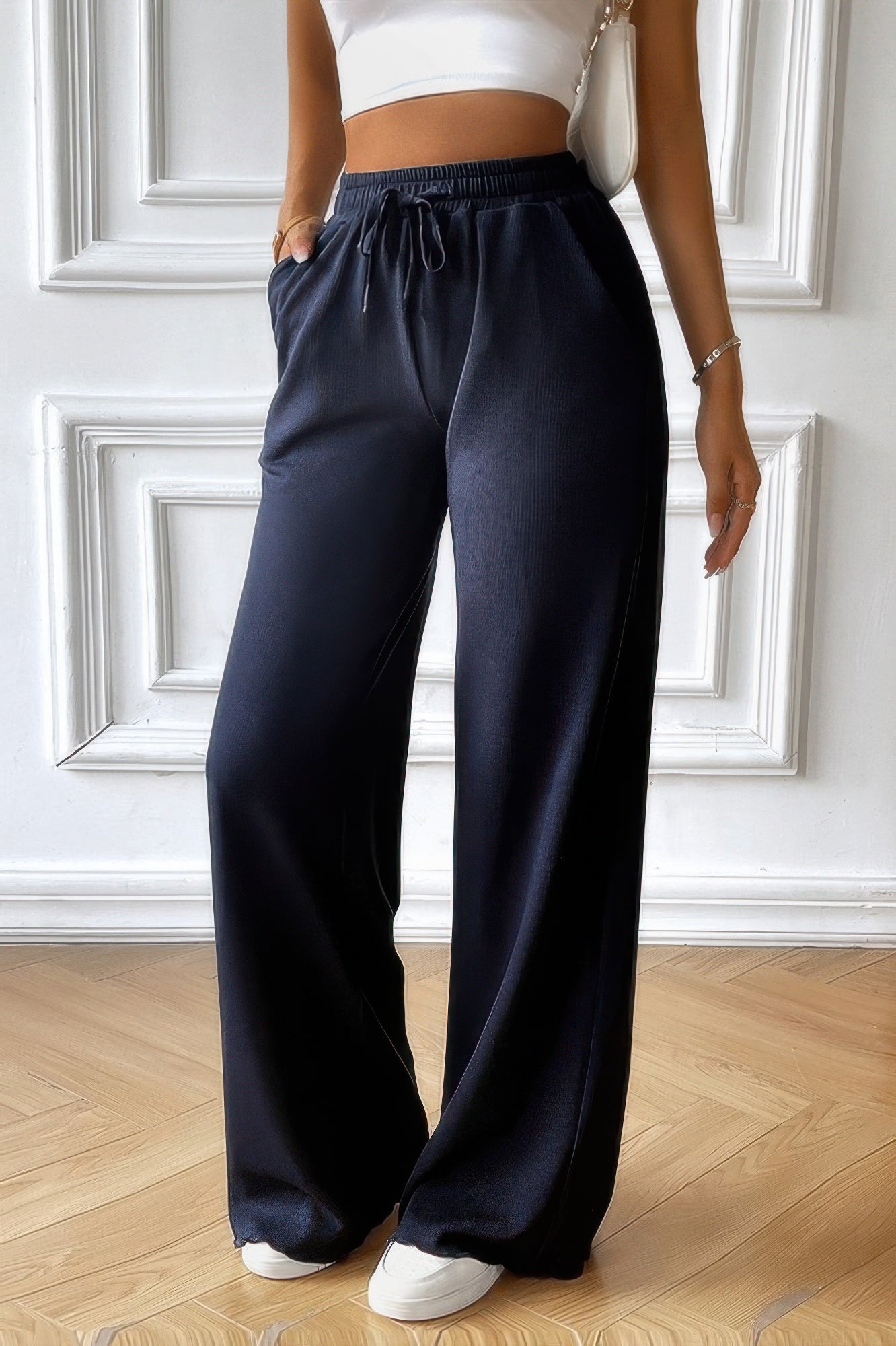 Model wearing CCWHOLESALECLOTHING women's elastic waist straight pants in black with drawstring pockets and relaxed fit