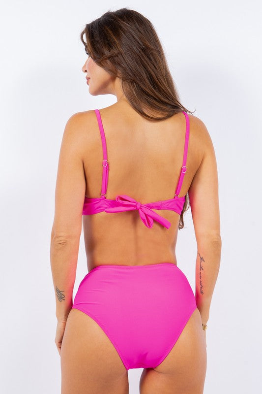 Model wearing vibrant pink bikini back with tied straps from Mermaid Swimwear White Wrap Bikini collection