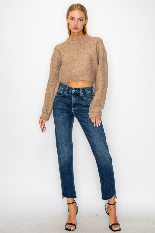 Artemis Vintage model wearing tummy control high rise jeans for women in dark wash with cropped sweater