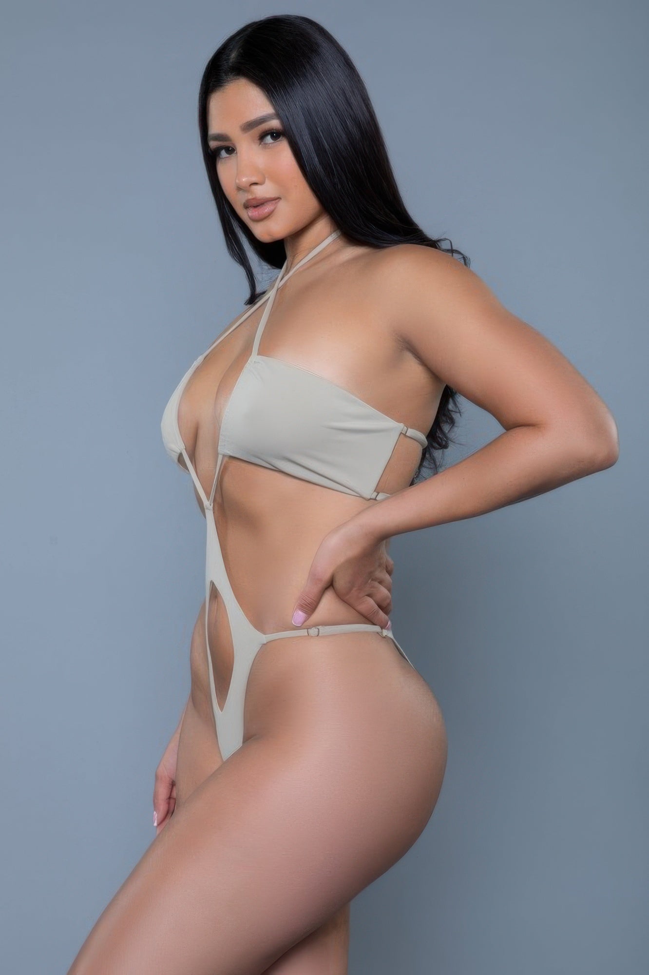 CCWHOLESALECLOTHING model wearing cutout yellow monokini swimsuit in beige neutral tone on gray background