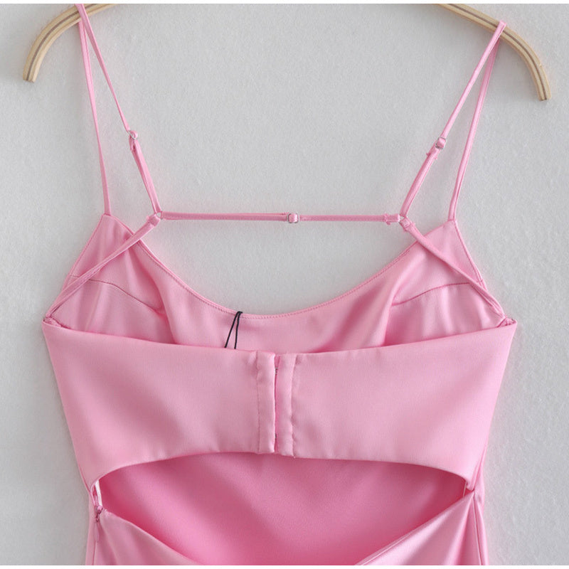 Trendsi pink satin slip dress with adjustable spaghetti straps hanging on wooden hanger