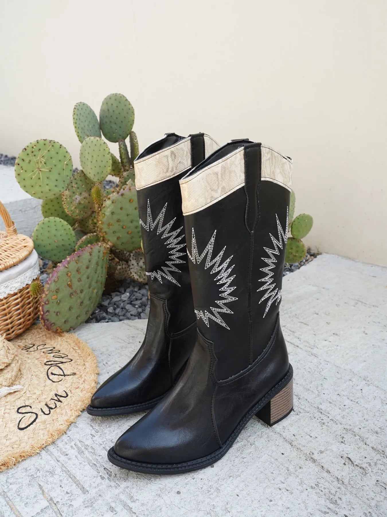 Trendsi black Point Toe Low Block boots with star design and beige trim on desert background