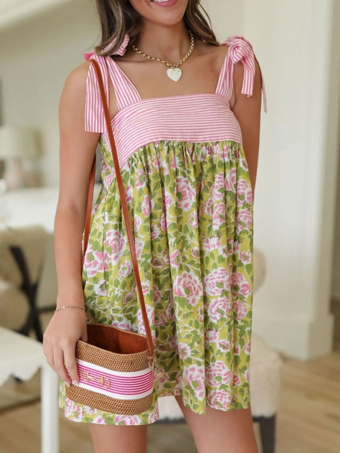 Trendsi Tie Shoulder Mini Dress pink striped bodice and green floral skirt model wearing straw crossbody bag